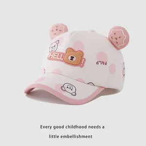 Detail of pink polka dot kids baseball cap with cute 3D bear ears and HELLO badge