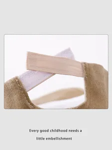 Detail of adjustable hook-and-loop strap on a khaki kids baseball cap with tidy stitching