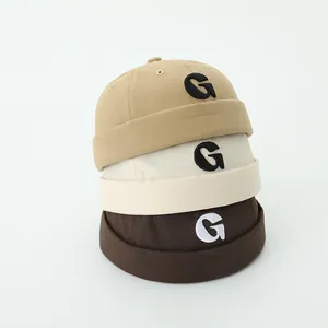 Set of three children's brimless Docker hats in khaki and beige with G embroidery