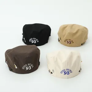 Detailed close-up of vintage cotton canvas berets with STND BY ME 93 embroidery