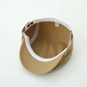 Detail view of khaki cotton beret interior showing sweatband and stitch quality
