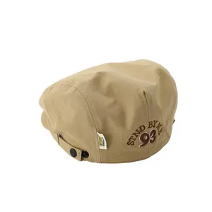 Khaki canvas kid's newsboy cap featuring 93 embroidery and adjustable strap
