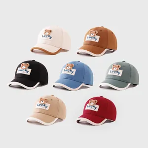 Detailed view of kids cotton baseball caps in seven colors with plush bear patches