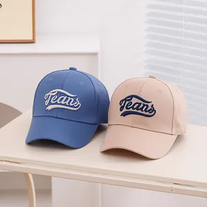 Detailed close-up of blue and beige cotton baseball caps with Jeans embroidery detail