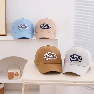 Detail of multi-color kids baseball caps featuring 3D Teans embroidery and cotton texture