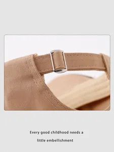 Detail of khaki cotton baseball cap showing sturdy silver metal buckle and neat stitching