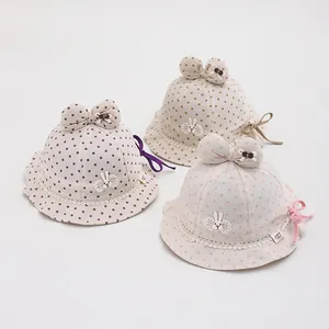 Detail of baby sun hats with polka dots, cute rabbit patches and lace edges