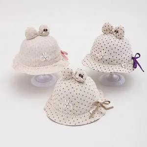 Detailed view of baby sun hats featuring polka dots, lace trim, and cute rabbit embroidery