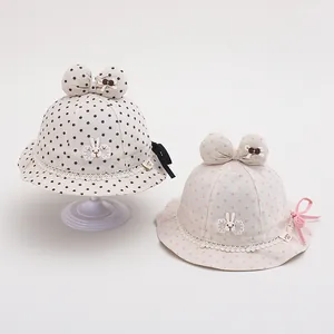 Cute polka dot baby sun hat with bunny patch and lace trim, displayed in two colors