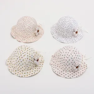 Detail of floral baby sun hats with fabric flower accents in pastel assorted colors