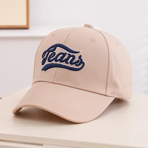 Close-up of blue Jeans embroidery on beige cotton twill baseball cap for kids