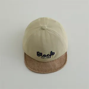 Two-tone cotton baby baseball cap with Black EST. 1983 embroidery and soft brim detail