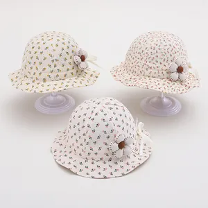 Three colors of floral cotton baby sun hats with ribbon bows and fabric flower accents