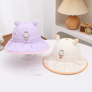 Detail of baby sun hats featuring cute rabbit ice cream embroidery and ruffled brims