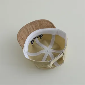 Infant beige baseball cap with brown straw brim and Black embroidery detail