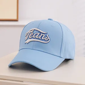 Detail of light blue baseball cap featuring intricate Jeans embroidery and twill texture