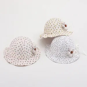 Close-up of floral baby sun hats with 3D fabric flowers and secure chin straps