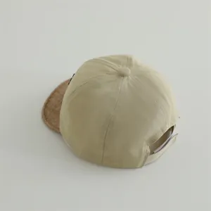 Detail view of cotton baby baseball cap with adjustable strap and contrast brown brim