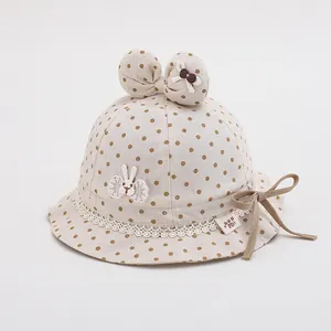 Cute beige polka dot baby sun hat with bunny ears and lace trim for toddler girls
