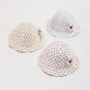 Detailed close-up of baby floral bucket hats with 3D fabric flowers and soft cotton texture