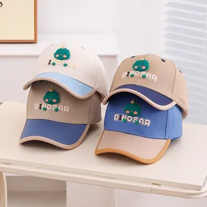 Close-up of assorted kids dinosaur baseball caps in various contrast color combinations