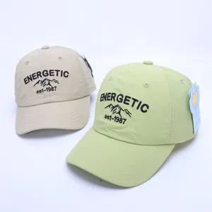 Detail view of breathable summer baseball caps with energetic mountain embroidery