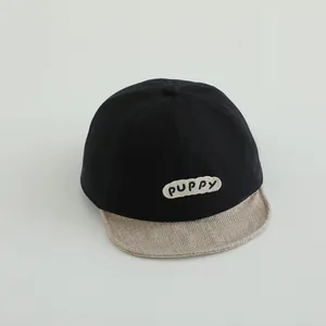 Detail of the soft-brim baseball cap showing the PUPPY patch and cotton fabric texture