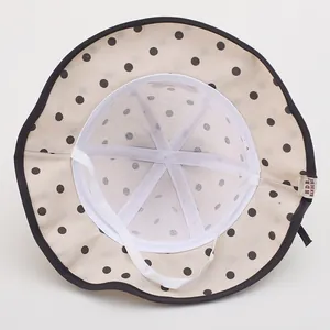 Detail of baby sun hat showing breathable mesh lining and adjustable chin strap
