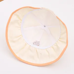 Detailed interior of kids sun hat showing breathable mesh lining and orange piping trim
