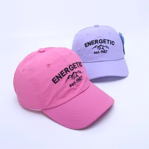 Detail of pink and purple kids baseball caps with Energetic embroidery and soft fabric
