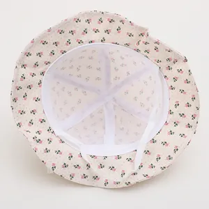 Detail of baby sun hat showing breathable mesh lining and cotton floral print design
