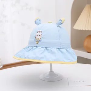 Detail of light blue sun hat for kids featuring bunny ice cream embroidery and mesh vents