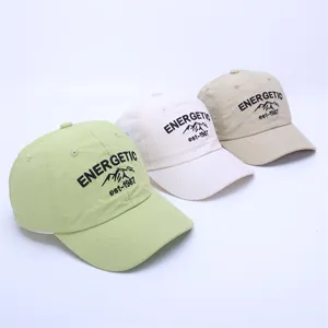 Detailed view of lightweight quick-dry baseball caps in mint green, white, and beige colors