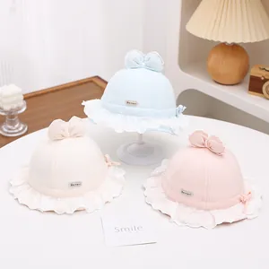Close-up of baby sun hats featuring delicate lace edges and dual-layered bow details