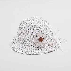 Detail of baby floral bucket hat with 3D fabric flower and white chin strap ties