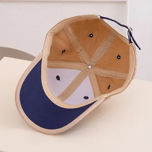 Macro shot of baseball cap interior showing six-panel stitching and metal buckle