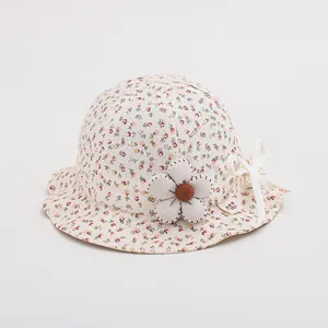 Close-up of floral baby sun hat with plaid flower decoration and delicate white bow detail