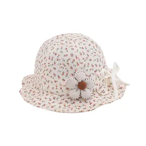 Floral baby sun hat with bow and decorative flower on cream cotton fabric for toddlers