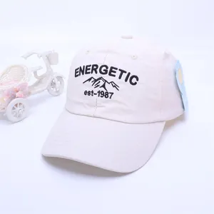 Detail view of off-white kids baseball cap with energetic embroidery and curved brim