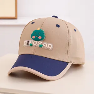 Close-up of 3D rubber green dinosaur patch and DINOSAR text on kids baseball cap