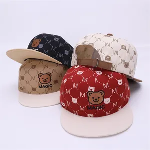 Detail view of colorful kids' hip-hop baseball caps with teddy bear and MAGIC embroidery