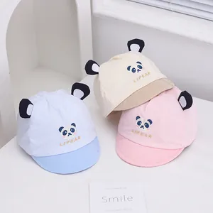 Detailed view of baby cotton panda baseball caps in blue, beige and pink soft brim