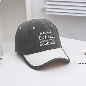 Close-up of COFFEE embroidery and premium stitching on two-tone kids baseball cap