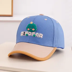 Detail of blue toddler baseball cap with 3D green dinosaur patch and DINOSAR text