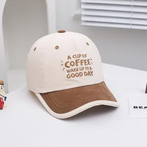Macro detail of COFFEE letter embroidery on contrast color cotton kids baseball cap