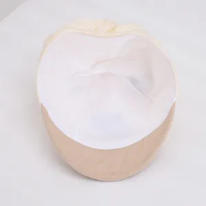 Detail of baby baseball cap interior showing white breathable lining and elastic band