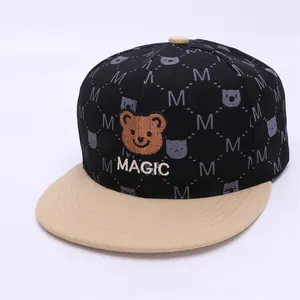 Detail of cartoon bear embroidery and MAGIC text on a two-tone hip hop baseball cap
