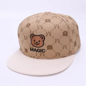 Detailed close-up of kids hip hop cap with bear embroidery and M pattern print