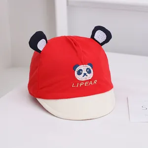 Detail view of baby soft brim panda cap in red cotton with cute ear decorations