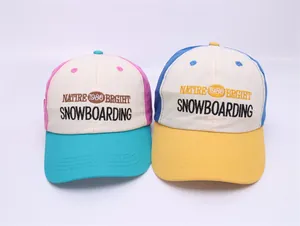Detail of color-block baseball caps with vintage embroidery and premium fabric texture